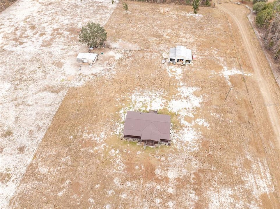 Aerial showing house, shop, and animal enclosure(s)