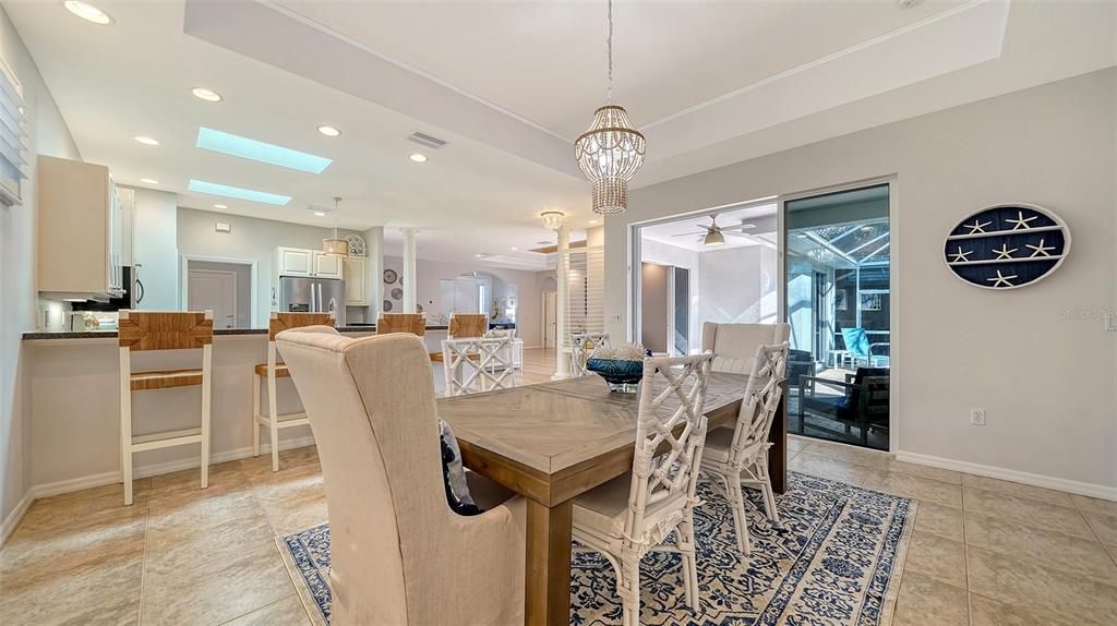 Large breakfast counter and dining room with Serena and Lilly fixtures