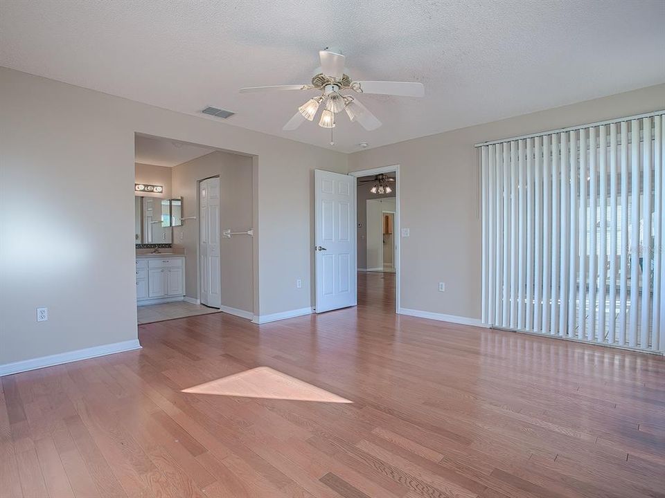 BLINDS OPEN TO GLASS SLIDERS THAT LEAD TO THE LANAI