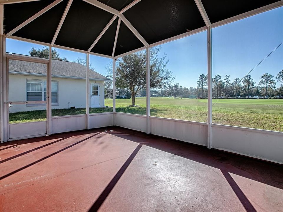 STEP OUTSIDE AND ENTER THE SCREENED LANAI AND BIRDCAGE TO REALLY APPRECIATE THE GOLF FRONT VIEW! COVERED