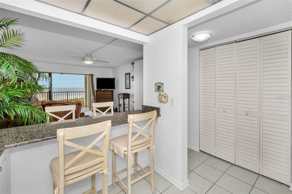 Light & Bright Kitchen with Granite Surfaces, Breakfast Bar and White Appliances.