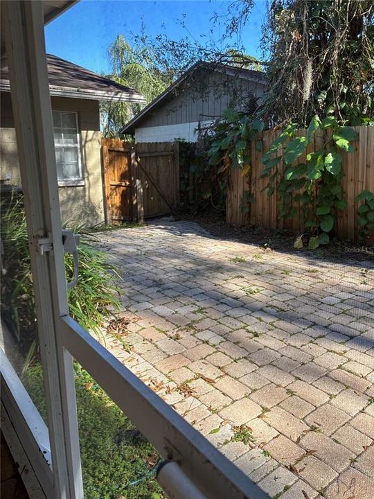 Current pavered patio off lanai.  Fenced backyard.