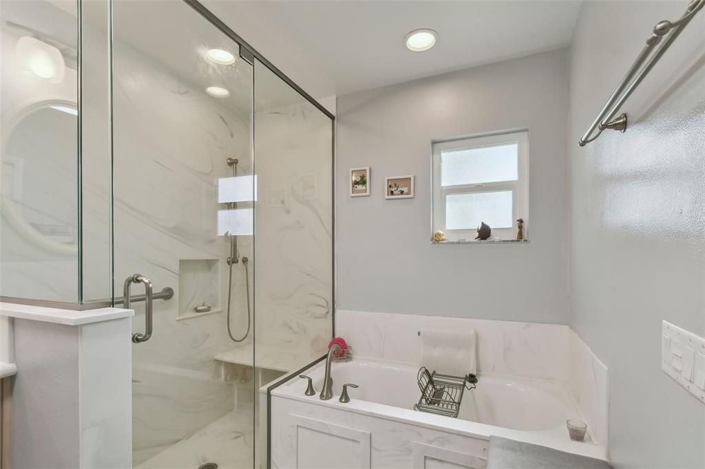 Primary bathroom separate tub & show with beautiful finishes