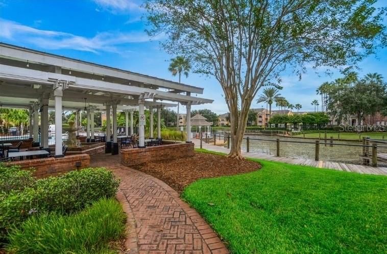 View of the outdoor seating at Splash Chill & Sports Bar & restaurant located poolside and overlooking pond.