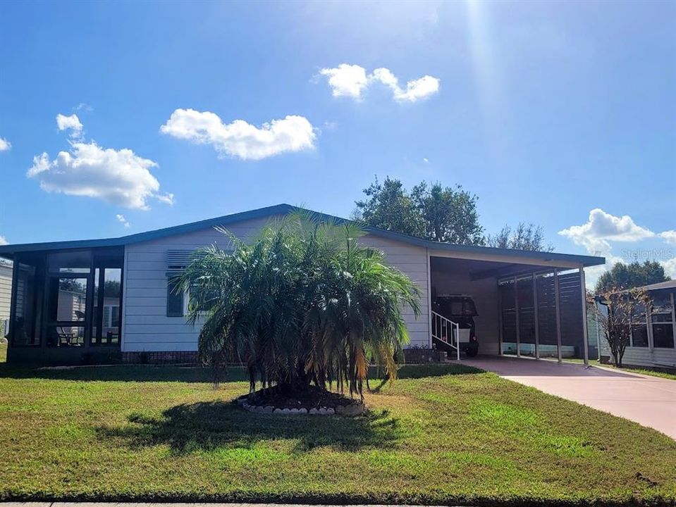 driveway leads to covered carport