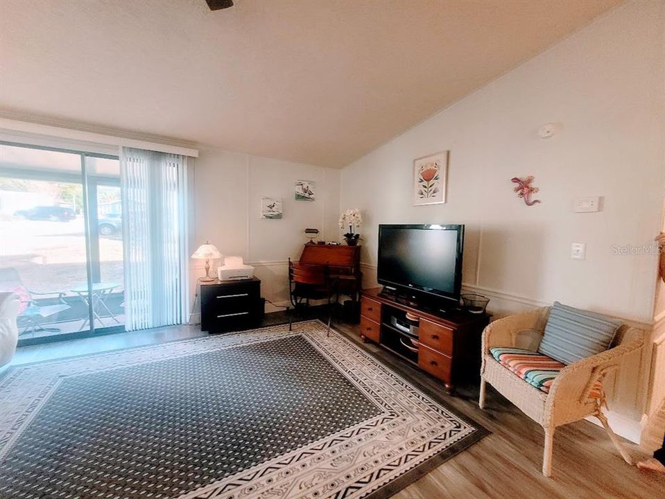 open living room with nice natural light opens to the screen room