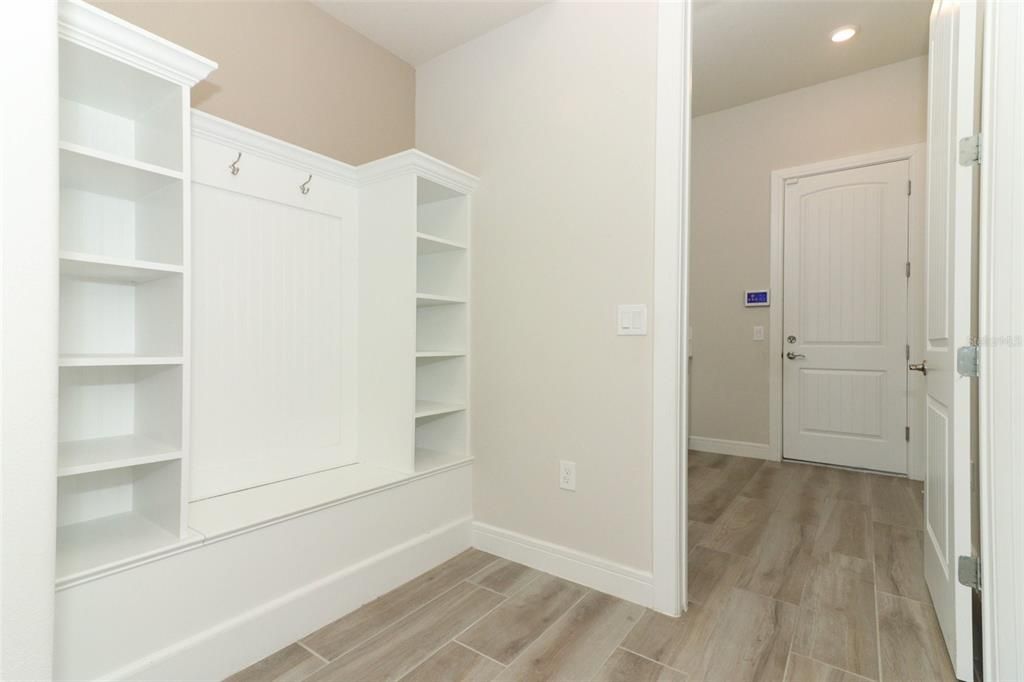 "mud room with built-in shelves & bench