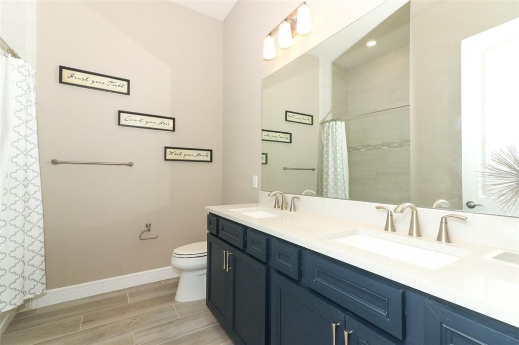 Secondary bathroom with shower & double sinks,