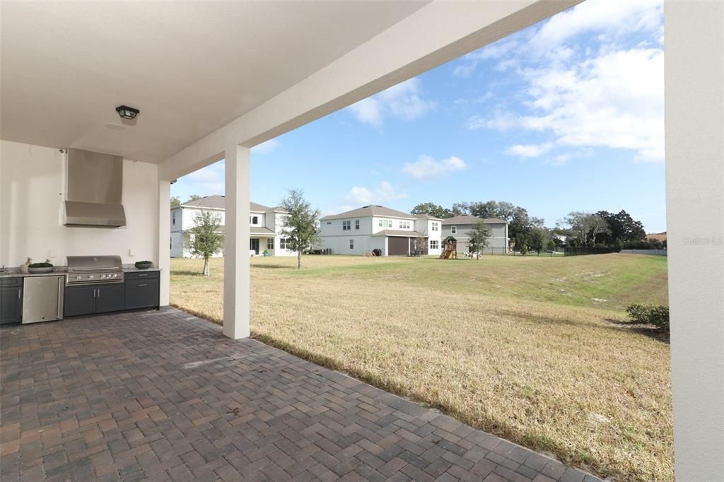 Spacious covered lanai overlooking large open space