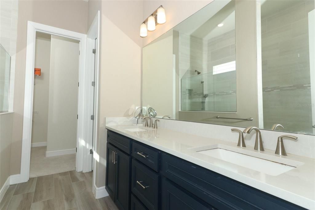 Primary bathroom with double sinks, double mirrors & lots of storage space.