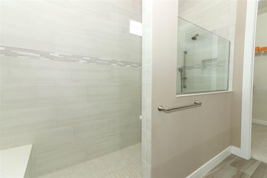 Primary bathroom with double sinks, walk-in shower. large double closet bathroom