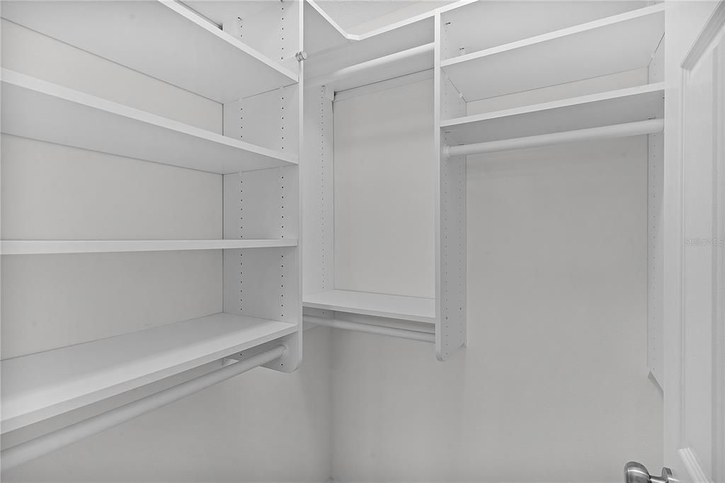 2nd bedroom walk in closet with organization