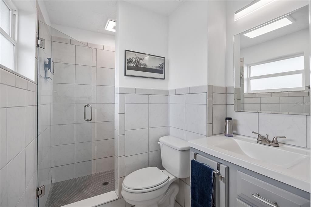 The Primary Bathroom has been fully updated and has a large shower with frameless glass door.