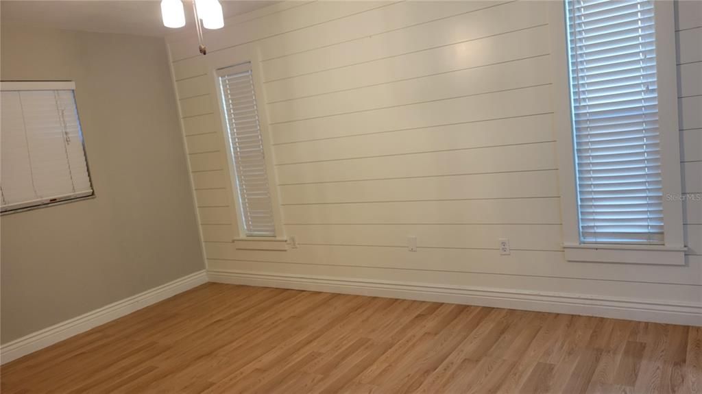 main bedroom with ship lap accent wall