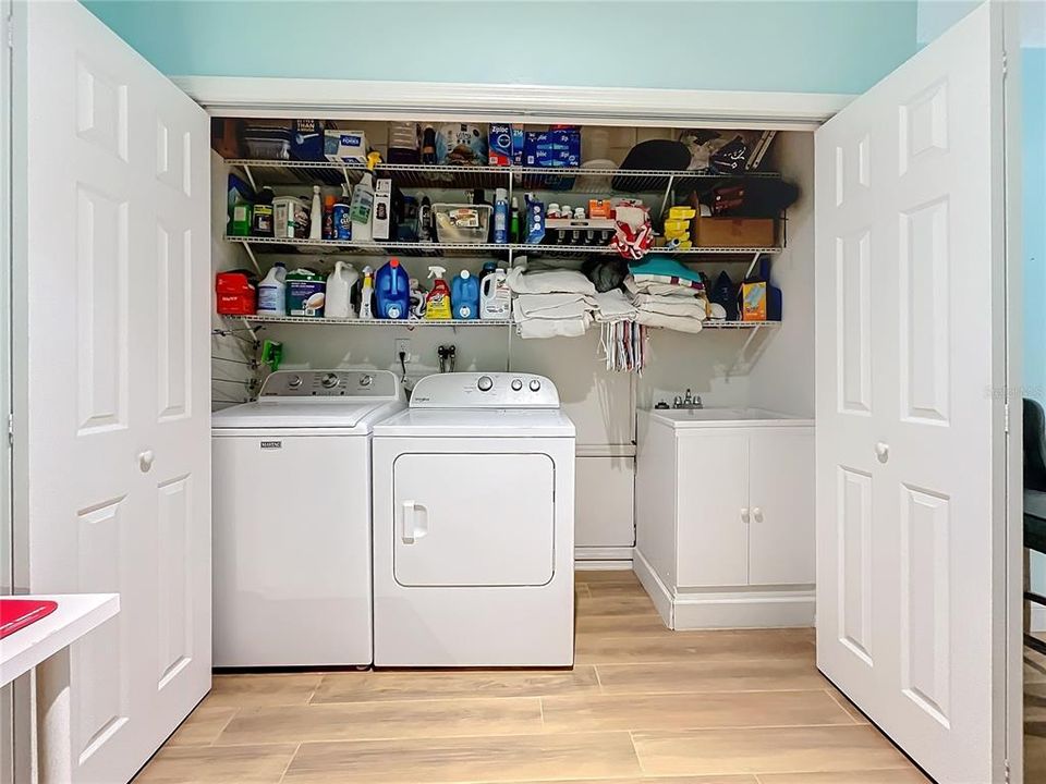 laundry area with sink and storage