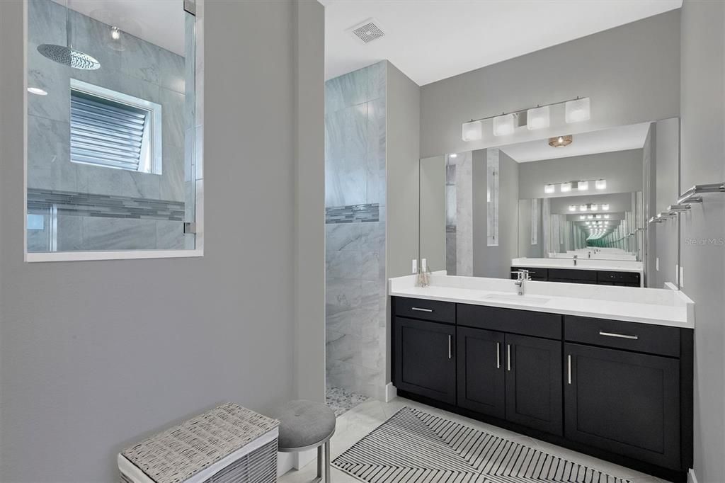 Elegant Primary Bath with a Luxurious Shower and Dual Vanities