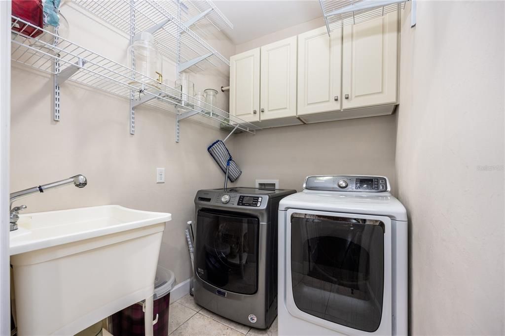 Laundry room with laundry tub and washer and dryer