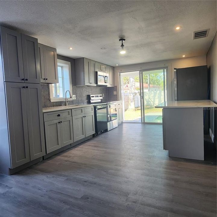 Kitchen with sliding doors to backyard.