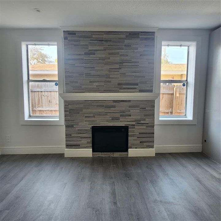 Beautiful fireplace! Note all of the wood details: mantel, window trim, baseboards, and trim at the top of the fireplace.