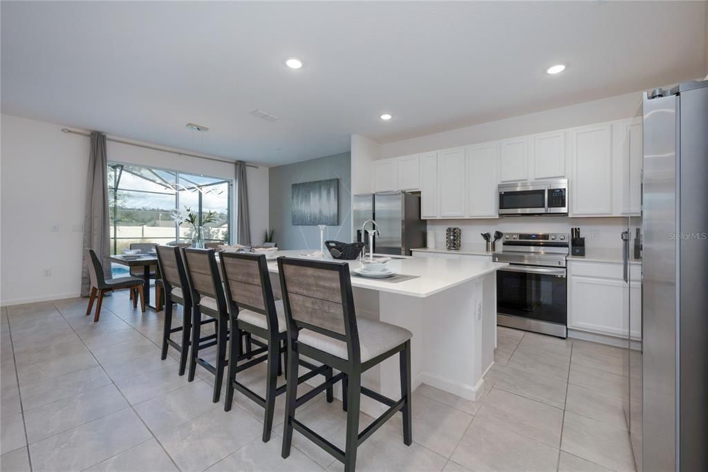 Tile floors throughout the open kitchen, living and dining make maintenance breeze and site lines straight through from the foyer to the backyard add to the light and bright feel of this sprawling floor plan.