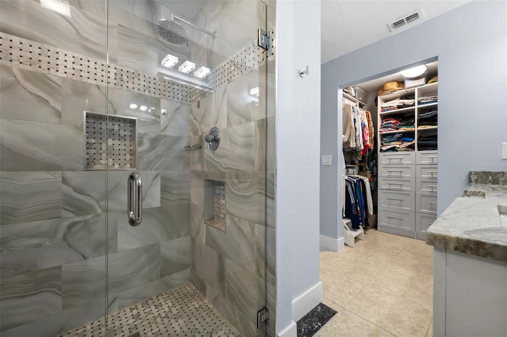 Glass Wall Shower and Walk-in Closet in the Primary Bathroom