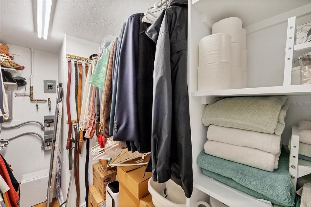 Walk-in closet with organizers and tankless water heater