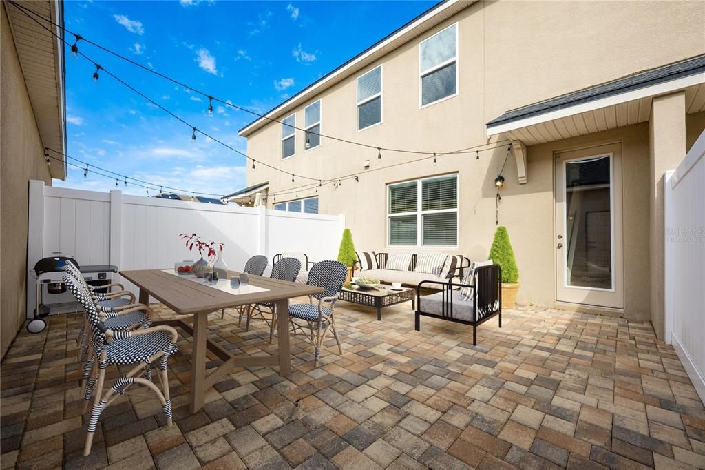 Virtually Staged: Large courtyard / patio connects home to detached garage