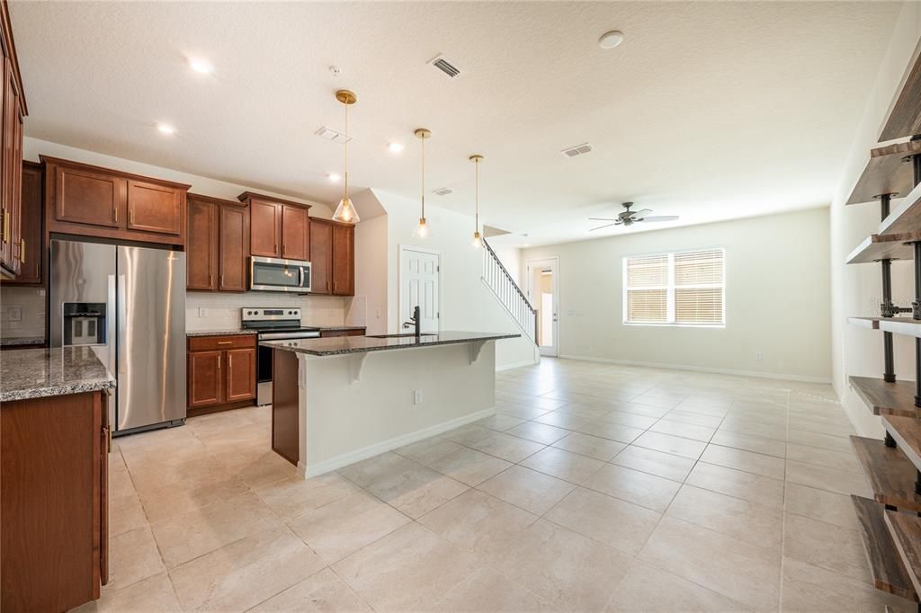 Virtually Staged: Central kitchen overlooks breakfast nook and living room