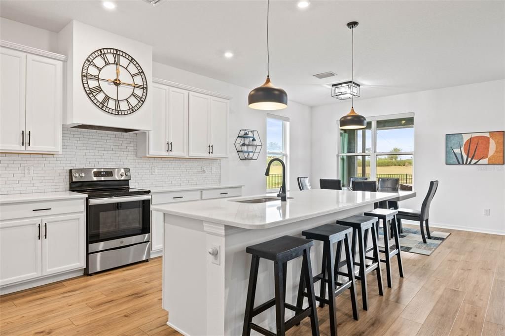 The kitchen has stainless steel applianes, quartz countertops, 42" shaker cabinetry, and seating for 4 at the island.  Plenty of counter space.