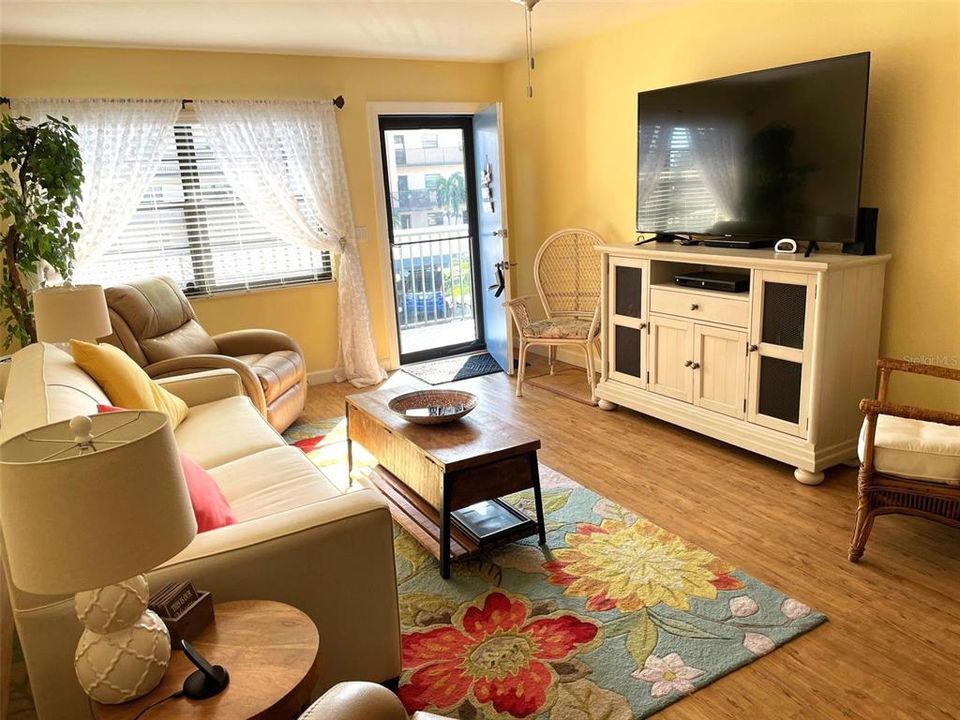 Light, bright living room with vinyl plank floor