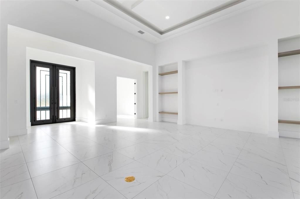 Entry doors from kitchen island showing office door on right