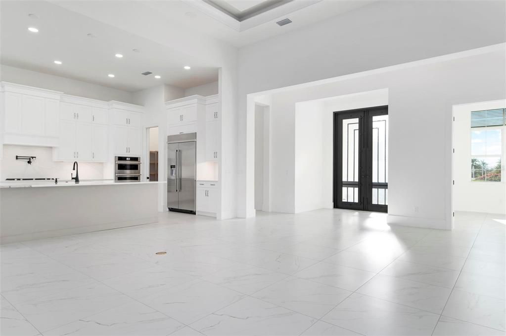 First glimpse of kitchen with front entry doors visable