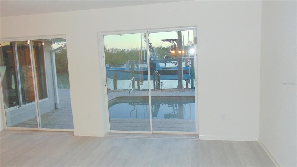 Family room looking over the water and dock to the south, new flooring and paint.