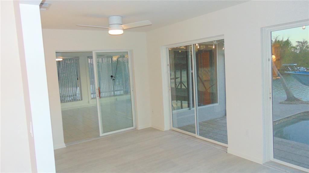 Family room with view of the water and dock to the south, other room is the entertainment/game room. After flooring and new paint was finished through out entire home.