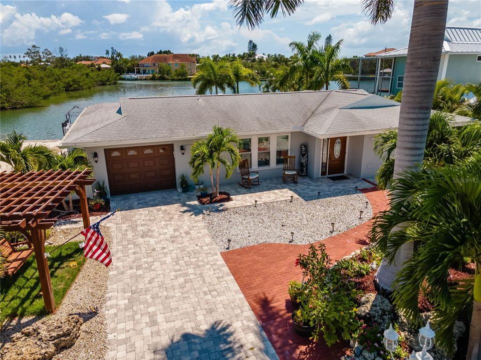 Protective cove pictured behind the home. ICW is just to the left. Massive royal palms adorn the front of the property which are very impressive, smaller ones all around the sides and rear of the property.