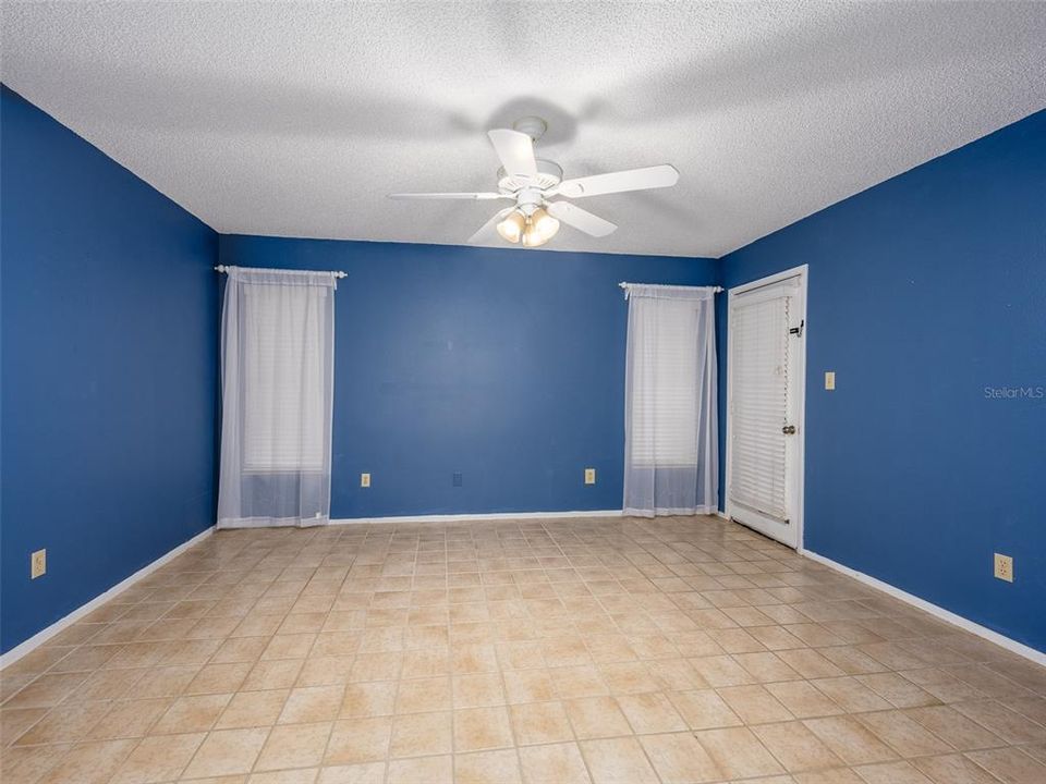 Primary bedroom with door to pool area