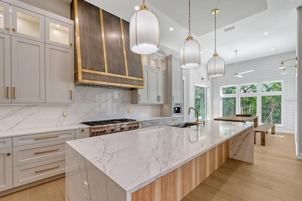 This state-of-the-art kitchen offers oversized island and opens to dining area.