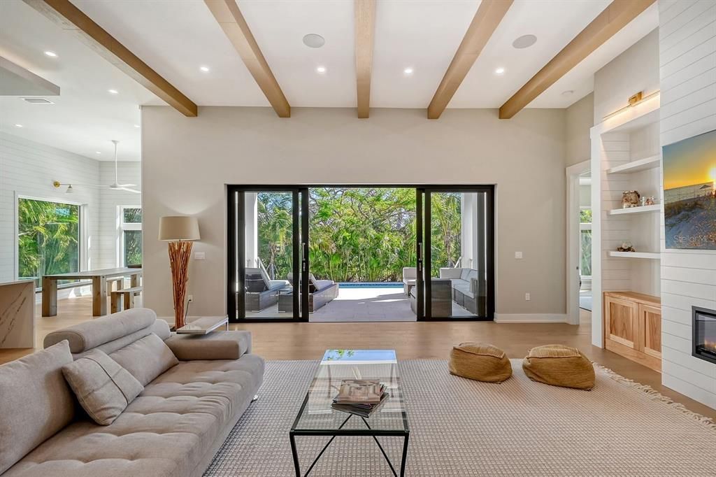 Generous windows and sliding glass doors create an airy atmosphere with a connection to nature and outdoor life.