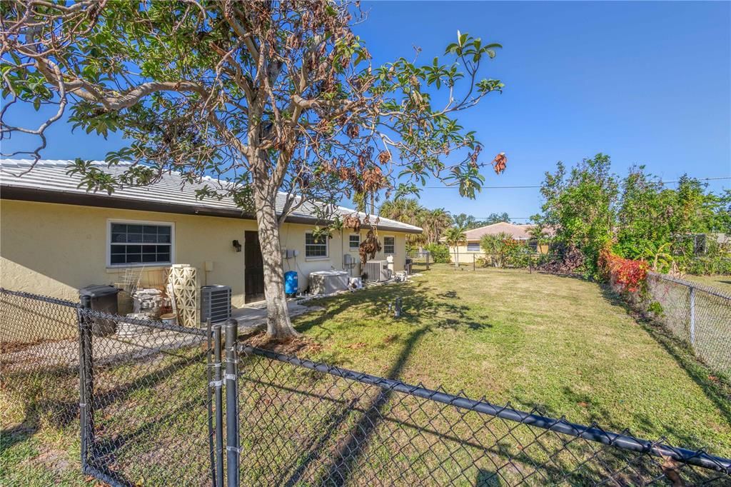 fenced side yard has doggy door from pool area