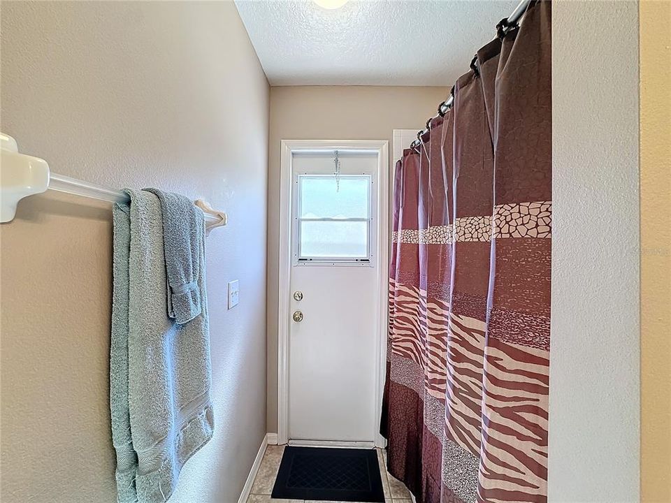 The guest bathroom has a bathtub with shower.