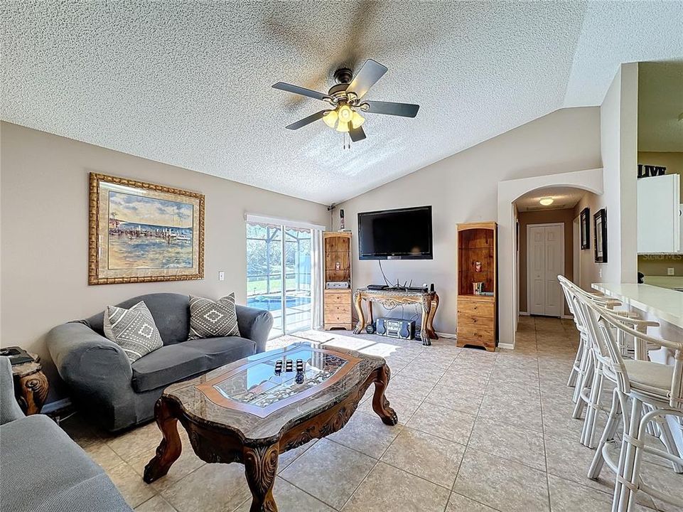 The living room has sliding glass doors to take you out back to the pool and pond, or go down the hallway to the two guest bedrooms and the guest bathroom.