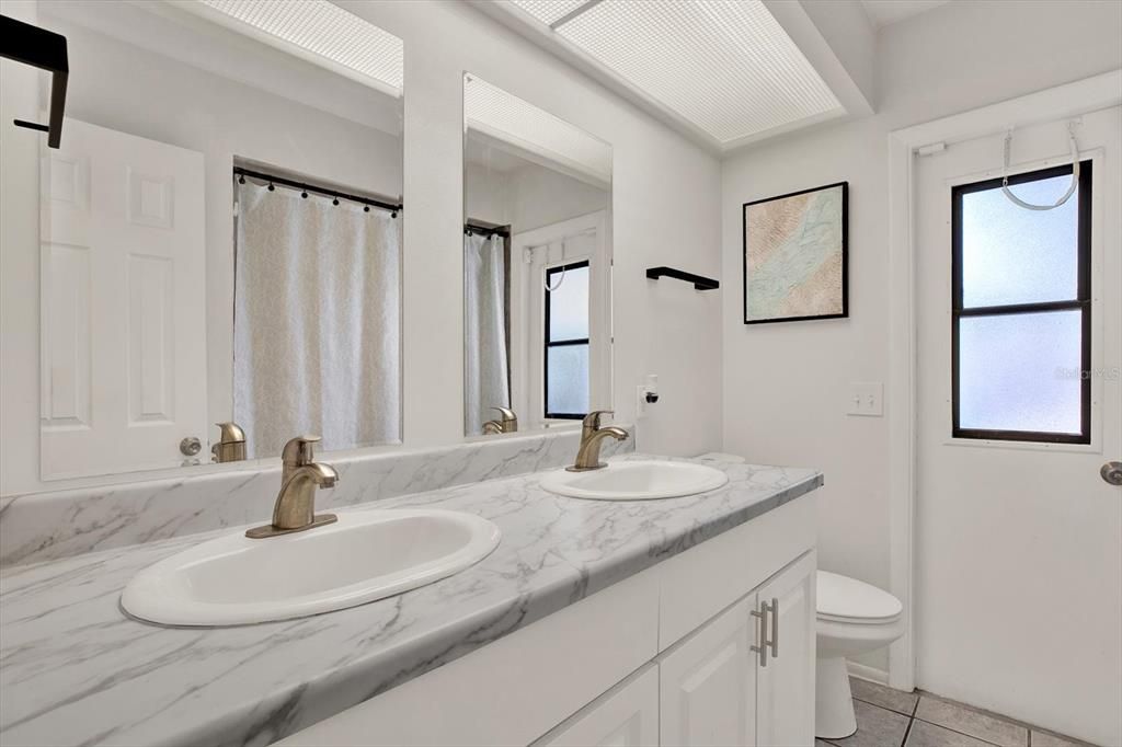 Hallway Bathroom with door to the pool