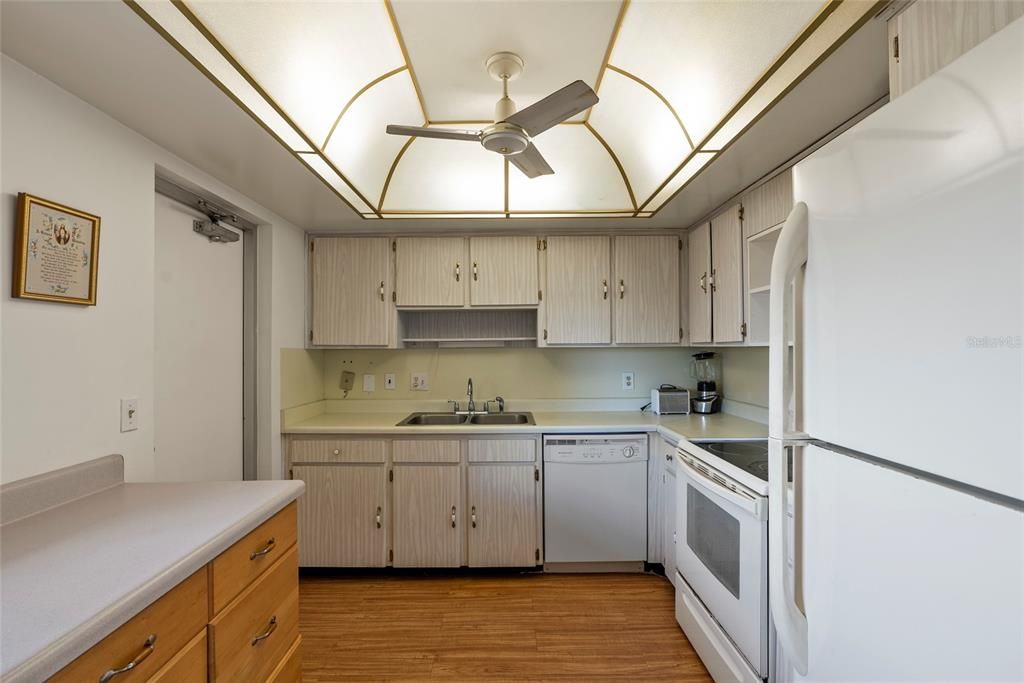 Kitchen, on your left between the cabinets is a door that leads to the hallway.