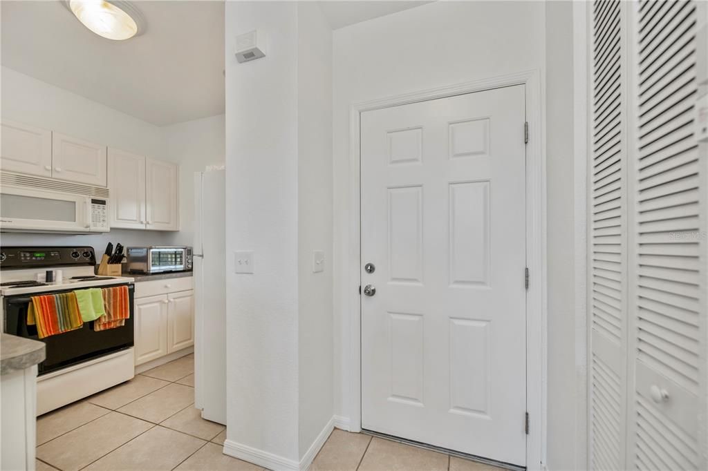 Front door foyer entry, kitchen, and utility closet.