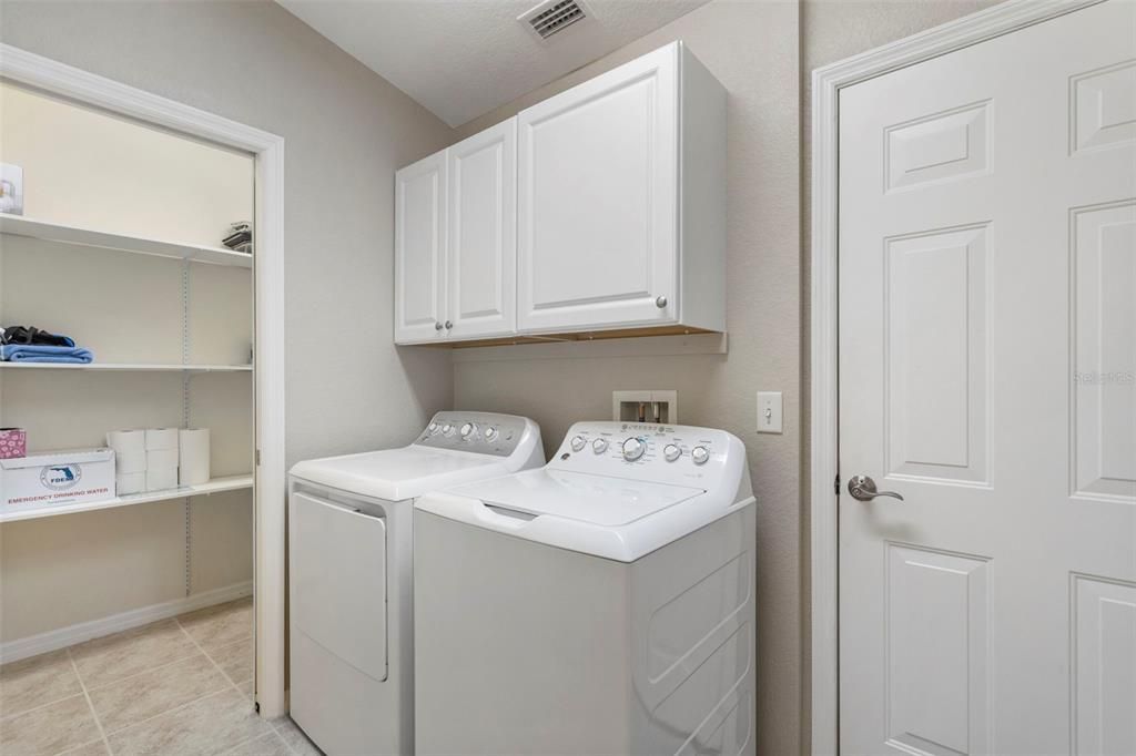 Inside laundry with additional storage closet.