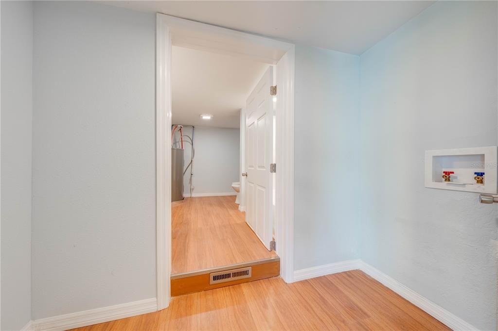 laundry room and entrance into 2nd bathroom