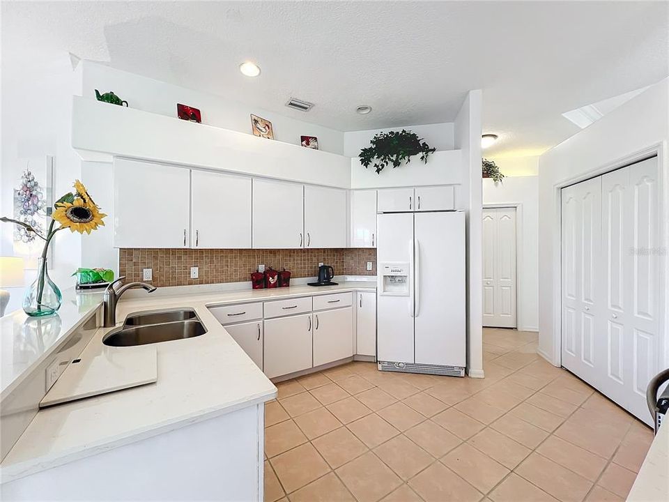 European cabinet design solid surface counter & tile backsplash.