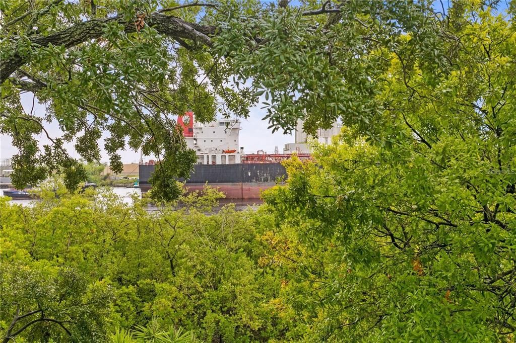 With birds eye view of cargo ships coming and going from your balcony