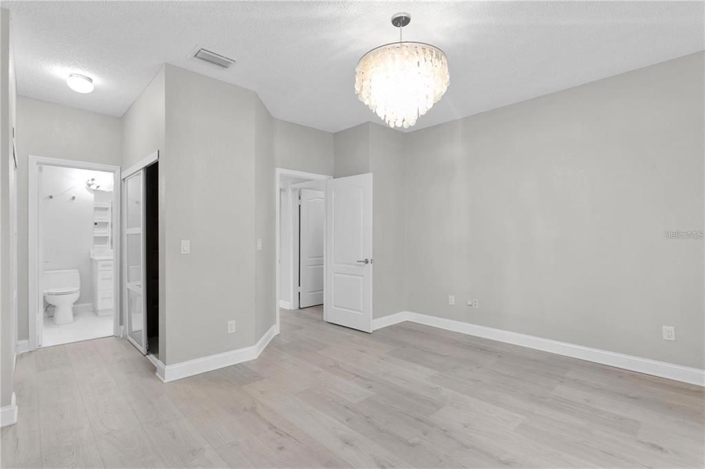 Primary bedroom with walk in closets and bathroom attached