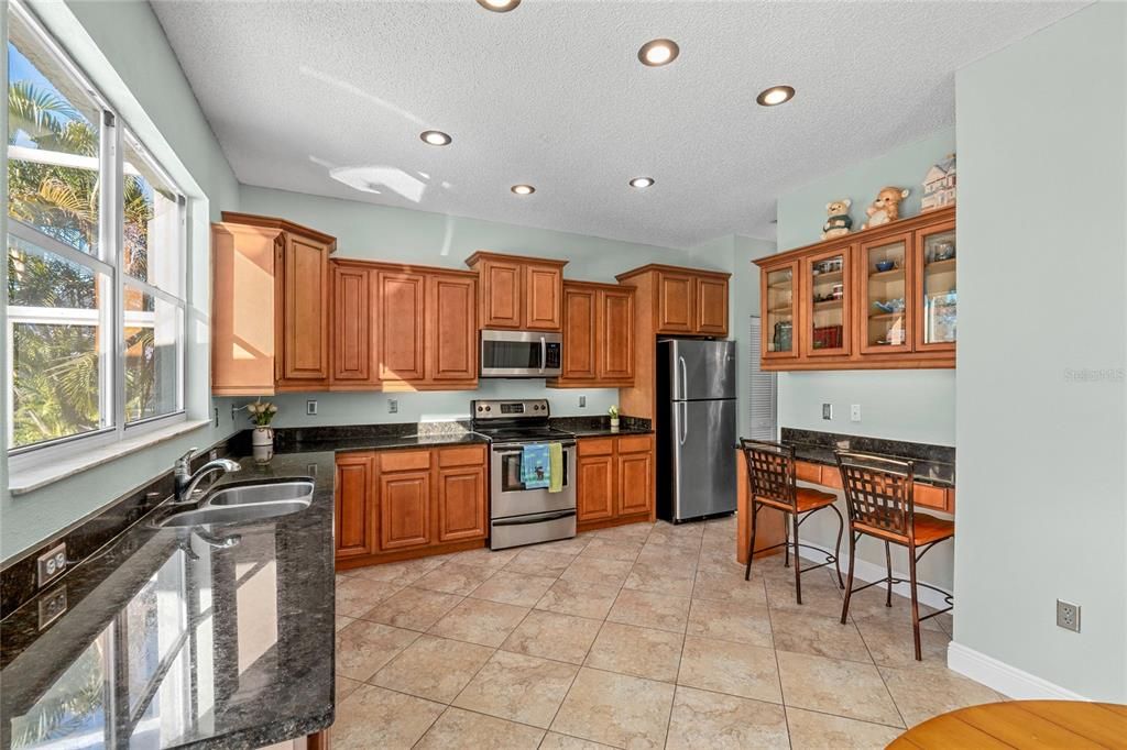 Wood Cabinets and granite countertops in this well appointed Kitchen